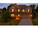 Charming two-story home features a brick and siding exterior, attached two-car garage, and a well-manicured front lawn at 4360 Carver Ct, Cumming, GA 30040