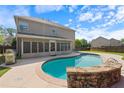 Sparkling pool with stone details, alongside a screened-in porch and spacious patio perfect for relaxing at 4360 Carver Ct, Cumming, GA 30040