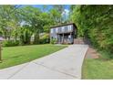 Charming two-story home with a long concrete driveway and a well-manicured lawn at 479 Clifton Se St, Atlanta, GA 30316
