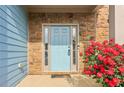 Close up of the front door with stone accents and red flowers at 4970 Roseman Trl, Cumming, GA 30040