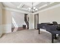 Open-concept living room with coffered ceilings, and a staircase at 4970 Roseman Trl, Cumming, GA 30040
