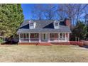 Attractive brick home featuring a covered front porch, ideal for relaxing and enjoying the outdoors at 6841 Fairway Ridge Dr, Douglasville, GA 30134