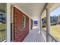 Charming front porch with classic columns and ample space, perfect for outdoor seating and relaxation at 6841 Fairway Ridge Dr, Douglasville, GA 30134