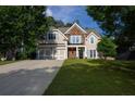 Well-manicured front yard leads to this two-story home featuring a two-car garage and stylish stone accents at 36 Evergreen Way, Dallas, GA 30157