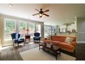 Open-concept living room with hardwood floors, large windows and a ceiling fan at 36 Evergreen Way, Dallas, GA 30157