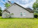 Exterior side view of the home featuring vinyl siding at 1528 Buckingham Pl, Stockbridge, GA 30281
