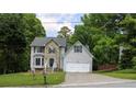 Charming two-story home with stone accents, gray siding, well-manicured lawn and a two car garage at 2317 Rocksram Ct, Buford, GA 30519