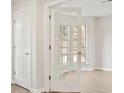 Bright, neutral space with hardwood floors and a glass paneled door allowing an abundance of light at 2317 Rocksram Ct, Buford, GA 30519