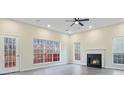Spacious living room featuring a fireplace, recessed lights, ceiling fan, and large windows at 2317 Rocksram Ct, Buford, GA 30519