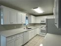 Modern kitchen featuring white cabinets, stylish countertops, and stainless-steel appliances at 820 Emerald Forest Cir, Lawrenceville, GA 30044