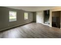 Bright living room with wood-look flooring, natural light, and easy access to the staircase at 820 Emerald Forest Cir, Lawrenceville, GA 30044