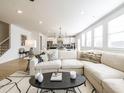 Bright living room featuring a large sectional sofa, modern rug, and an open floor plan at 1715 Fulmont Cir, Mableton, GA 30126