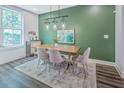 Stylish dining area featuring hardwood floors, modern lighting, and an accent wall at 24 Becker Nw Pl, Atlanta, GA 30307