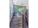Stylish dining area featuring hardwood floors, modern lighting, and an accent wall at 24 Becker Nw Pl, Atlanta, GA 30307