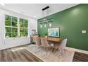 Modern dining room with stylish decor, window view, and accent wall at 24 Becker Nw Pl, Atlanta, GA 30307