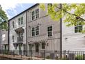 Well-maintained townhome exteriors featuring a black fence, a pergola, and greenery at 24 Becker Nw Pl, Atlanta, GA 30307