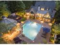 Backyard paradise featuring a large pool, gazebo, and lush landscaping at 4140 Hillside Nw Pl, Atlanta, GA 30342