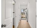 Hallway with hardwood floors and view of front yard at 225 Kenoot Dr # 50, Mcdonough, GA 30253