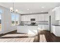 Bright kitchen with white cabinets, island, stainless appliances, and ample counter space at 6935 Melody Ridge Rd, Buford, GA 30518
