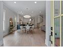 Open-concept living space with hardwood floors and modern lighting at 357 Mell Ne Ave, Atlanta, GA 30307