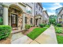 Attractive stone and brick townhome with well-manicured landscaping and sidewalk at 3676 Brookhaven Manor Ne Xing, Atlanta, GA 30319