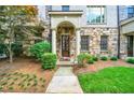 Beautiful stone and brick townhouse with a welcoming entrance and lush front lawn at 3676 Brookhaven Manor Ne Xing, Atlanta, GA 30319