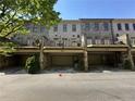Rear exterior view of townhomes with private garages and decks overlooking the parking area at 3676 Brookhaven Manor Ne Xing, Atlanta, GA 30319