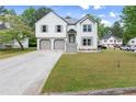Charming two-story home with a well-manicured lawn, a two-car garage, and a inviting entrance at 4258 Anderson Ridge Way, Austell, GA 30106
