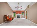 Inviting living room with fireplace, ceiling fan, and neutral carpet at 5525 Tallantworth Trl, Cumming, GA 30040
