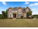 Imposing two-story brick house featuring a covered front porch and lush landscaping at 365 Freeman Sw Ter, Atlanta, GA 30331