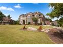 Elegant brick home with manicured lawn and charming butterfly garden decor at 365 Freeman Sw Ter, Atlanta, GA 30331