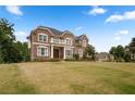 Stately brick home with a well-manicured lawn and balcony, showcasing classic elegance at 365 Freeman Sw Ter, Atlanta, GA 30331