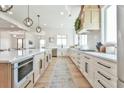 Bright, modern kitchen with a large island, stainless steel appliances, and custom cabinetry at 5315 Hendrix Rd, Cumming, GA 30040