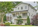 Beautifully landscaped two-story home with a cozy front porch and a two-car garage at 1059 Antioch Dr, Brookhaven, GA 30319