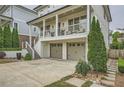 Exterior view of a home featuring a two-car garage and meticulous landscaping at 1059 Antioch Dr, Brookhaven, GA 30319