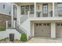 Close up on the front exterior featuring a charming porch and a two-car garage at 1059 Antioch Dr, Brookhaven, GA 30319