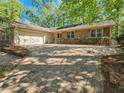 Inviting brick home with a two-car garage, a brick paver driveway, and attractive landscaping for enhanced curb appeal at 2735 Shetland Dr, Decatur, GA 30033