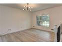Bright living room showcasing wood floors, fresh white walls, and large window at 6454 Boca Grande Blvd, Forest Park, GA 30297