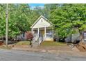 Charming front exterior view of the house featuring a yellow front door and a cozy front porch at 898 Allene Sw Ave, Atlanta, GA 30310