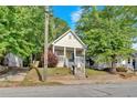 Charming front exterior view of the house featuring a yellow front door and a cozy front porch at 898 Allene Sw Ave, Atlanta, GA 30310