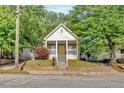 Charming front exterior view of the house featuring a yellow front door and a cozy front porch at 898 Allene Sw Ave, Atlanta, GA 30310