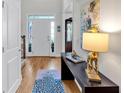 Bright entryway with hardwood floors, console table, and views of the front door at 905 Fox Croft Pl, Canton, GA 30114