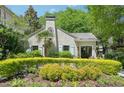 Charming exterior showcasing lush landscaping with green hedge and colorful flowers at 20 S Prado Ne, Atlanta, GA 30309