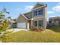 Charming two-story home with a lush, green lawn and beautiful blue shutters on the windows at 4428 Belcamp Rd, Fairburn, GA 30213