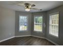 Bedroom with dark wood-look flooring, neutral paint, and bright, natural light at 3835 Portico Run Dr, Buford, GA 30519