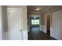 Inviting foyer features neutral paint, white doors, and dark wood-look flooring at 3835 Portico Run Dr, Buford, GA 30519