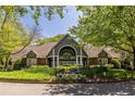 Inviting clubhouse with meticulously maintained landscaping, including lush lawns and colorful flower beds at 405 Mcgill Park Ne Ave, Atlanta, GA 30312