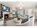 Bright open-concept living room with modern fireplace, chandelier lighting, and updated flooring at 4264 Windward Ln, Norcross, GA 30093