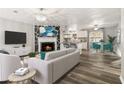 Spacious open-plan living room showcasing a fireplace, modern furniture, and seamless flow to the kitchen at 4264 Windward Ln, Norcross, GA 30093