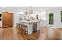 Modern kitchen with an oversized island, wine fridge, and stainless steel appliances at 751 Upper Burris Rd, Canton, GA 30114